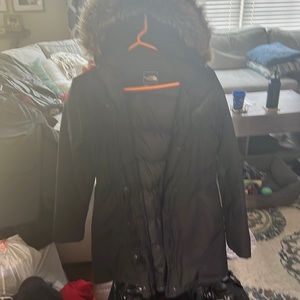 North face black, long coat with fur laced hood. In great shape!